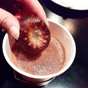 Dipping a canele into the ganache hot chocolate at Hendrickx